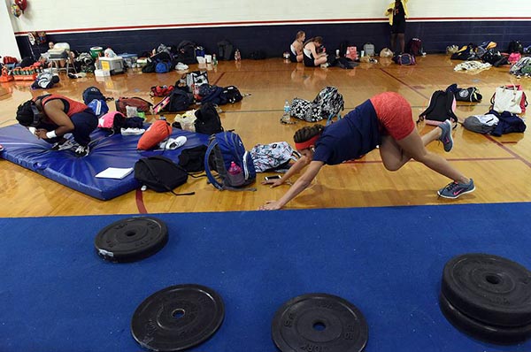 Manatee High students Monica Lowe and Gabriella Valdez stretch and warm up at the district girls weightlifting meet at Manatee Wednesday. Read more here: http://www.bradenton.com/latest-news/article54624595.html#storylink=cpy