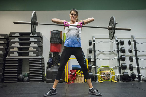 Ms. Agnos gave up long-distance running for high-intensity training and weights. Here, she performs a barbell Sumo dead lift to high pull. PHOTO: JOSH RICHIE FOR THE WALL STREET JOURNAL