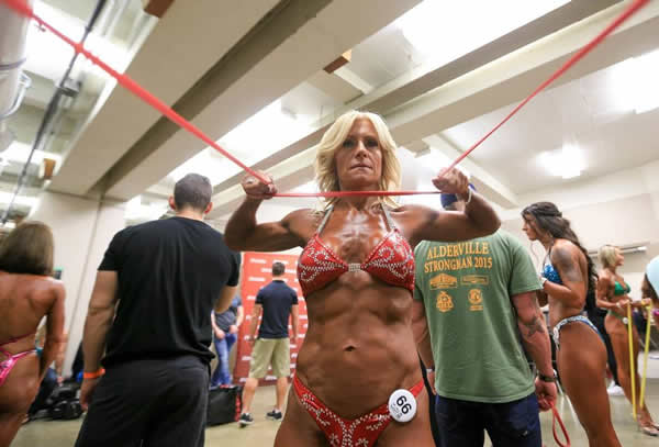 Bodybuilding grandmother Mary Dinner competing in the master bikini and figure competition at the Henderson Thorne Natural Classic, pumps up her muscles backstage before the start of the master bikini and figure competition. on Saturday, July 12, 2015 in Hamilton. Glenn Lowson photo for The Globe and Mail