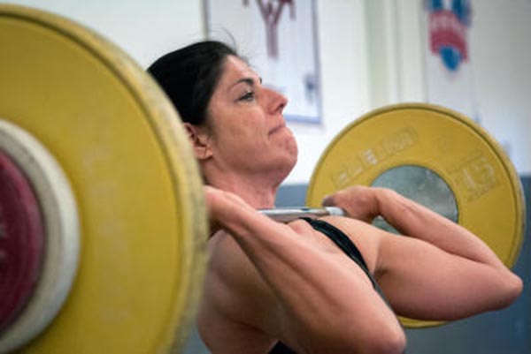 Jodi Stumbo, who completed a sweep of a Grand Slam of lifting events recently, works on her form at Miller’s Gym. 