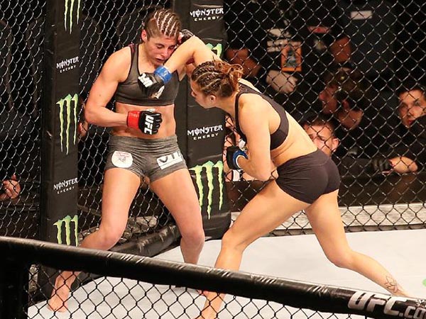 Alex Chambers on the back foot in her UFC bout with Kailin Curran (black shorts). Picture Sarah Reed
